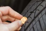 Checking tread depth on a tire by using a penny