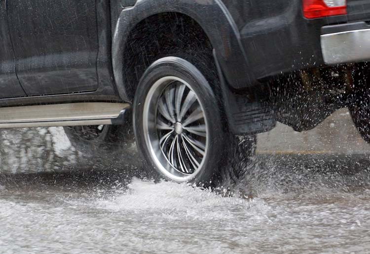 truck tires on wet road after rain