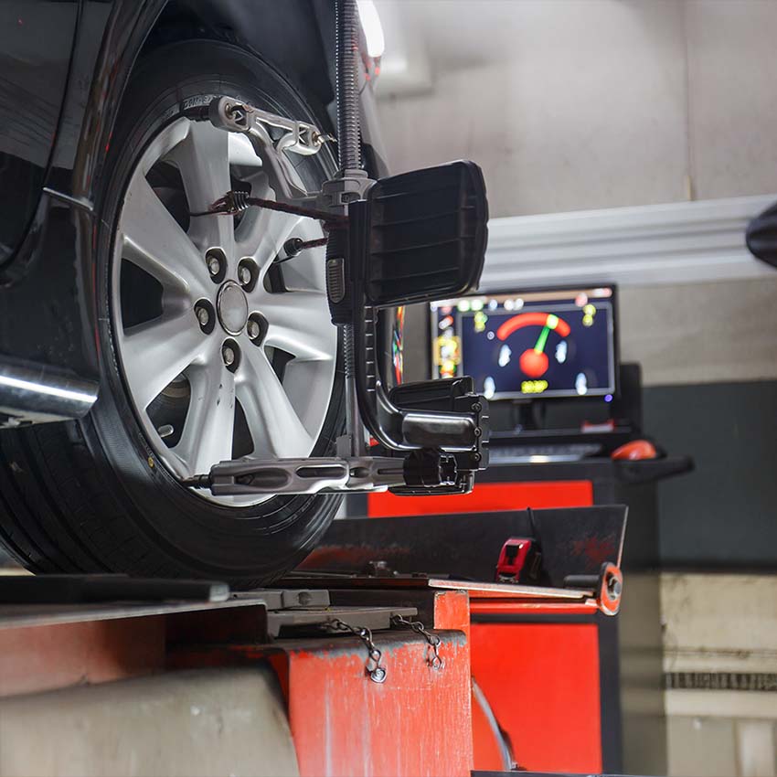 Car on stand with sensors on wheels for wheels alignment camber check in workshop of Service station.