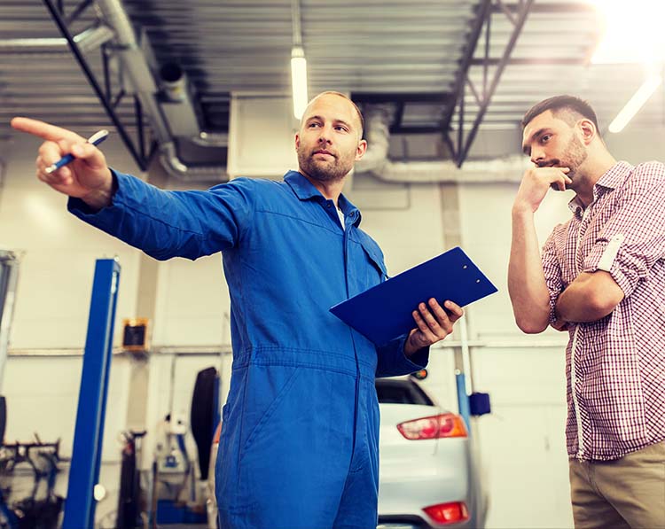 auto mechanic speaking to concerned customer